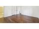 Large bedroom with dark hardwood floors, white walls, and access to another room at 5051 Heather Se Rd, Smyrna, GA 30082