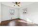 Bright, empty bedroom with hardwood floors, ceiling fan, and two windows at 5051 Heather Se Rd, Smyrna, GA 30082