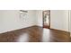 Empty bedroom with dark hardwood floors, white walls, and a door leading to the backyard at 5051 Heather Se Rd, Smyrna, GA 30082
