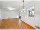 Bright dining room with wood floors, a unique light fixture, and sliding glass doors at 5051 Heather Se Rd, Smyrna, GA 30082