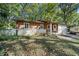 Single-story home with brick and wood exterior and attached carport at 5051 Heather Se Rd, Smyrna, GA 30082