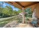Covered front porch with wicker chair overlooking the front lawn at 5051 Heather Se Rd, Smyrna, GA 30082