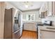 Updated kitchen boasts stainless steel appliances, white cabinets, and wood-style flooring at 5051 Heather Se Rd, Smyrna, GA 30082