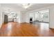 Living area with wood laminate flooring, ceiling fan, open concept layout, and a view to the kitchen and another room at 5051 Heather Se Rd, Smyrna, GA 30082
