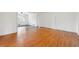 Open concept living area with wood laminate floors and view into adjacent room with dark hardwood floors at 5051 Heather Se Rd, Smyrna, GA 30082