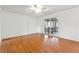 Spacious living room with wood laminate flooring, ceiling fan, and sliding glass door leading to the deck at 5051 Heather Se Rd, Smyrna, GA 30082