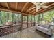 Relaxing screened porch with a ceiling fan, furniture, and wooded views at 5051 Heather Se Rd, Smyrna, GA 30082