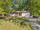 Front view of the single-story home with attached garage and driveway at 5051 Heather Se Rd, Smyrna, GA 30082