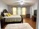 Main bedroom with king-size bed, two windows, and a ceiling fan at 345 Meadows Ln, Canton, GA 30114