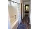 Bathroom with tub shower, and wood-look flooring at 345 Meadows Ln, Canton, GA 30114