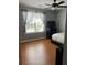 Bedroom with large window, wood-look floors, and TV at 345 Meadows Ln, Canton, GA 30114