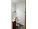 Clean bathroom with single sink vanity, toilet, and grey rug at 345 Meadows Ln, Canton, GA 30114