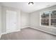 Well-lit bedroom with grey carpet and large window at 2725 Palmview Sw Ct, Atlanta, GA 30331