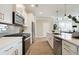 Modern kitchen with white cabinetry, stainless steel appliances, and a sleek quartz countertop at 3305 Cranston Ln, Kennesaw, GA 30144