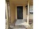 Home's front entrance with black door and brick accents at 255 Bellwood Ln, Riverdale, GA 30274