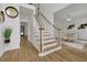 Grand staircase with hardwood floors and white railings at 3126 Crestmont Nw Way, Kennesaw, GA 30152