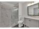 Updated bathroom with gray vanity, marble shower, and hexagon tile floor at 3126 Crestmont Nw Way, Kennesaw, GA 30152