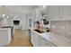 Modern white kitchen with marble countertops, stainless steel appliances, and a large island at 3126 Crestmont Nw Way, Kennesaw, GA 30152