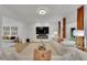 Bright living room with white sofas, orange curtains, and a modern fireplace at 3126 Crestmont Nw Way, Kennesaw, GA 30152