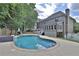 Inviting kidney-shaped pool with brick coping, a water feature, and a spacious deck at 3126 Crestmont Nw Way, Kennesaw, GA 30152