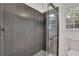 Large walk in shower with dark gray tile and frameless glass door at 3126 Crestmont Nw Way, Kennesaw, GA 30152