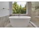 Relaxing bathroom featuring a freestanding tub and large window at 3126 Crestmont Nw Way, Kennesaw, GA 30152