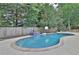 Relaxing kidney-shaped pool with tiled water feature and basketball goal at 3126 Crestmont Nw Way, Kennesaw, GA 30152
