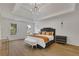 Spacious main bedroom with hardwood floors, large windows and a luxurious bed at 3126 Crestmont Nw Way, Kennesaw, GA 30152