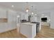 Bright kitchen featuring a white island with quartz countertop, stainless steel appliances, and hardwood floors at 3126 Crestmont Nw Way, Kennesaw, GA 30152