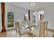 Modern dining room with glass table, gold chairs, and hardwood floors at 3126 Crestmont Nw Way, Kennesaw, GA 30152