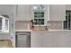 Modern kitchen featuring white cabinets, stainless steel appliances, and marble countertops at 3126 Crestmont Nw Way, Kennesaw, GA 30152