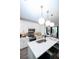 Modern kitchen with white cabinets, quartz countertops and island, open to living area at 392 Pratt Se Dr # 2012, Atlanta, GA 30315