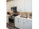 Modern kitchen with white shaker cabinets, herringbone backsplash, and stainless steel appliances at 392 Pratt Se Dr # 2012, Atlanta, GA 30315