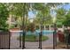 Community pool with brick border, pergola, and gate at 3621 Vinings Slope Se # 3411, Atlanta, GA 30339