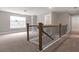 Spacious loft area with carpet flooring and a wooden staircase at 144 Crestbrook Way, Dallas, GA 30157