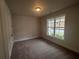 Spacious bedroom with carpeted floor and large window at 328 Willow Cv, Canton, GA 30114
