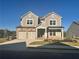 Two-story house with three-car garage and front yard at 328 Willow Cv, Canton, GA 30114