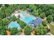 Aerial view of community pool, clubhouse, and surrounding green space at 328 Willow Cv, Canton, GA 30114