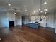 Open kitchen with an island, hardwood floors, and white cabinets at 328 Willow Cv, Canton, GA 30114
