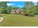 Brick home on a grassy hill with lush landscaping at 1175 Bowerie Chase, Powder Springs, GA 30127