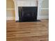 Elegant fireplace with dark stone hearth and hardwood floors at 1175 Bowerie Chase, Powder Springs, GA 30127