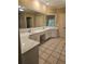 Double vanity bathroom with quartz countertops and tile floors at 1175 Bowerie Chase, Powder Springs, GA 30127