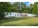 White ranch house with a large grassy yard at 115 Wilkins Rd, Fayetteville, GA 30214