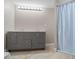 Bathroom with double vanity and light blue shower curtain at 115 Wilkins Rd, Fayetteville, GA 30214