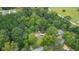 House nestled in a lush green wooded area at 115 Wilkins Rd, Fayetteville, GA 30214