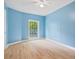 Light blue bedroom with hardwood floors and ceiling fan at 115 Wilkins Rd, Fayetteville, GA 30214