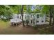 White house exterior with a deck and surrounding trees at 115 Wilkins Rd, Fayetteville, GA 30214