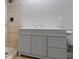 Modern gray vanity with a tile shower/tub combo at 115 Wilkins Rd, Fayetteville, GA 30214