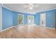 Spacious bedroom with light blue walls, hardwood floors, and access to a deck at 115 Wilkins Rd, Fayetteville, GA 30214
