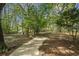 Wooded backyard with a large, grassy area at 115 Wilkins Rd, Fayetteville, GA 30214